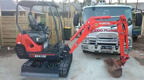 excavator and plumbing truck